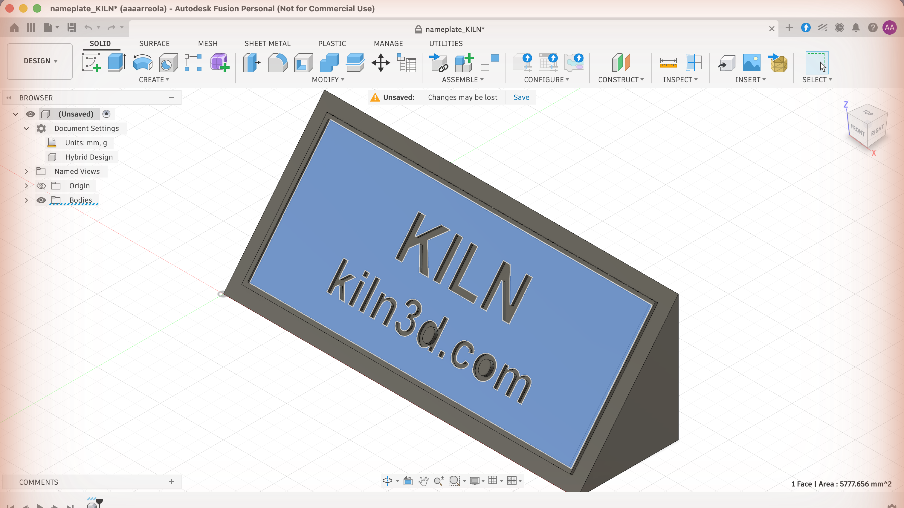 The sloped face of a nameplate carved with KILN and kiln3d.com, selected in Fusion so the status bar reports one face and its exact area in square millimetres