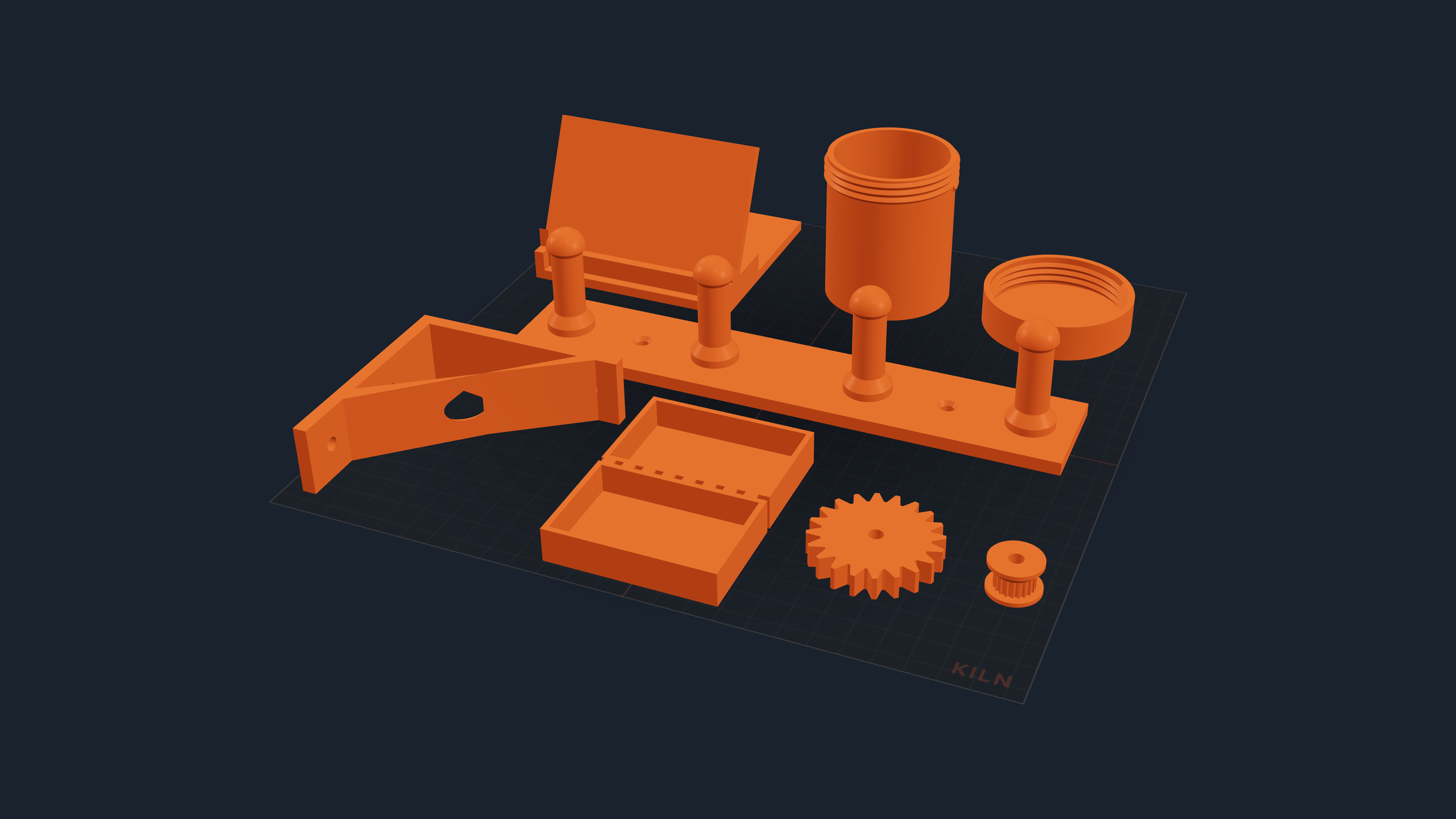 Seven of Kiln's ready-made parts laid out on one print bed in a single orange filament